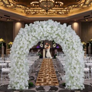 Elegant white floral wedding archway with artificial flowers for stage decoration provides the perfect backdrop for your photography.