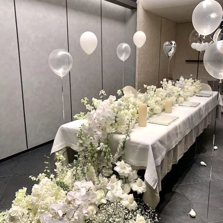 Elegant event table decor with artificial floral arrangements, supplied by trusted party supplies exporter handling bulk seasonal orders